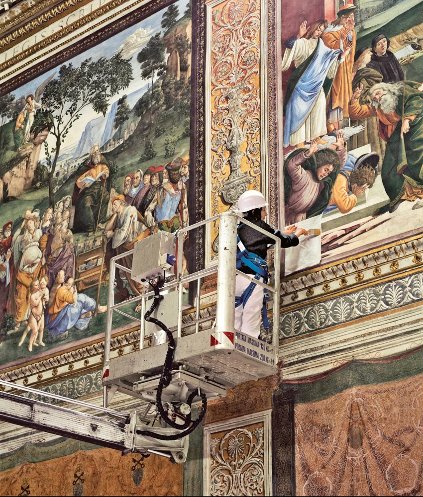 Restorers cleaning Michelangelo’s frescoes on scaffolding in the Sistine Chapel